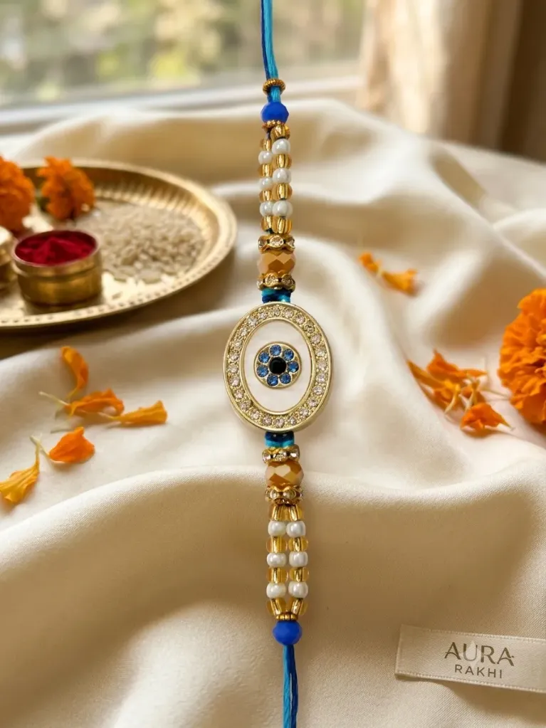 Evil Eye Designer Rakhi for Brother | Gold-Plated Oval Nazar Battu Rakhi with Blue Crystals